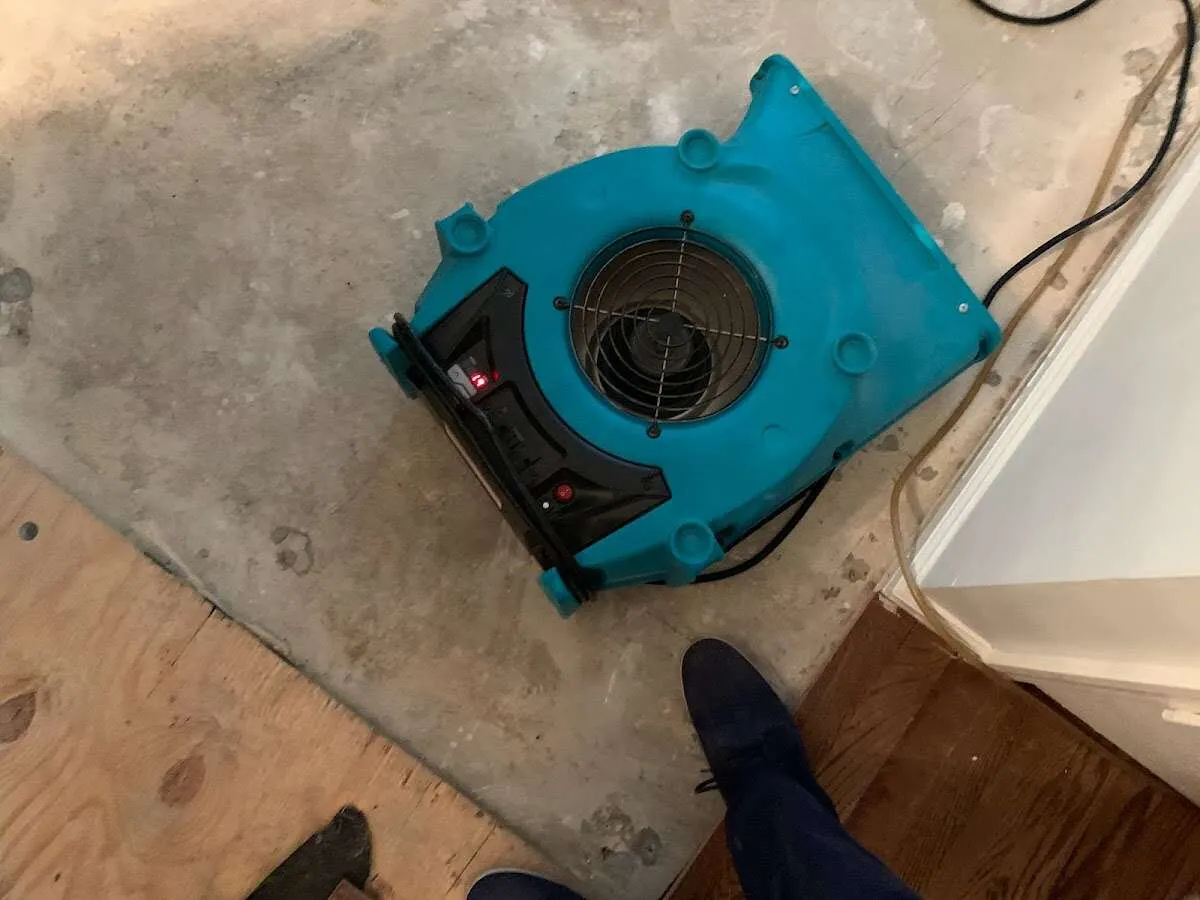 Air mover drying subfloor during Leak Detection & Repair in Uvalde